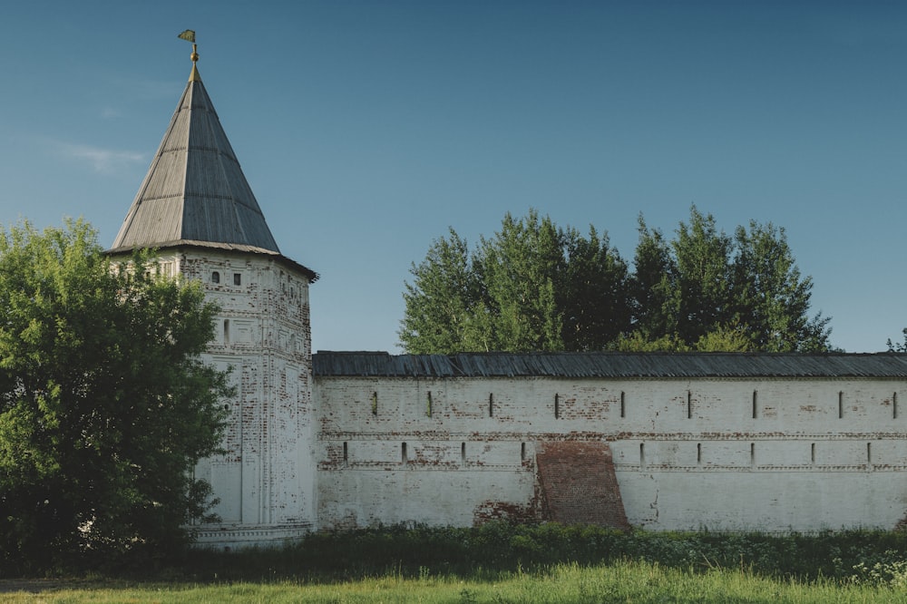 an old white building with a steeple on top of it