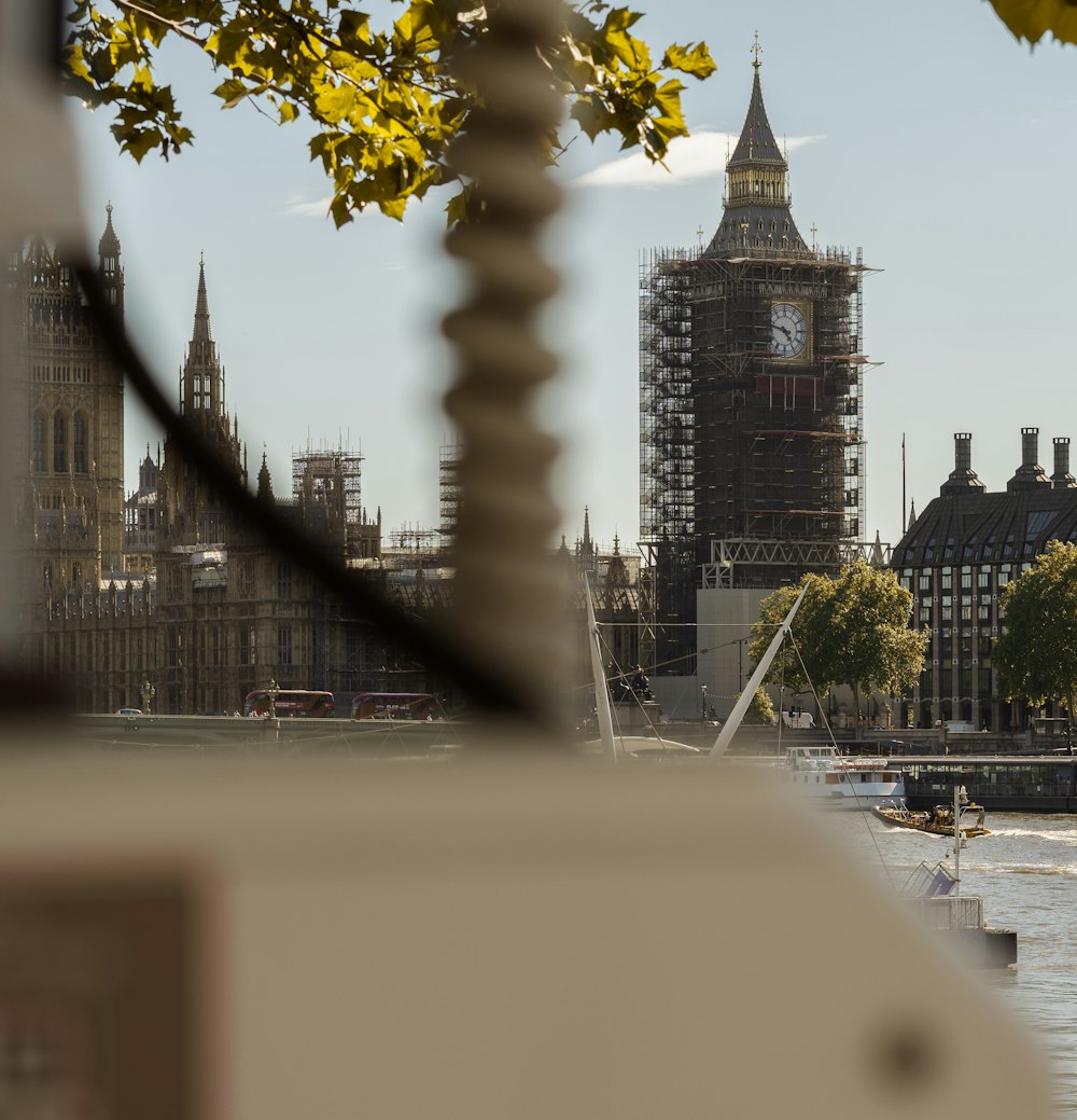 a view of a clock tower from across the river