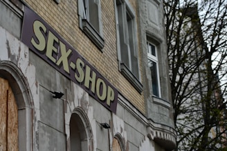 a sign that reads sex shop on the side of a building