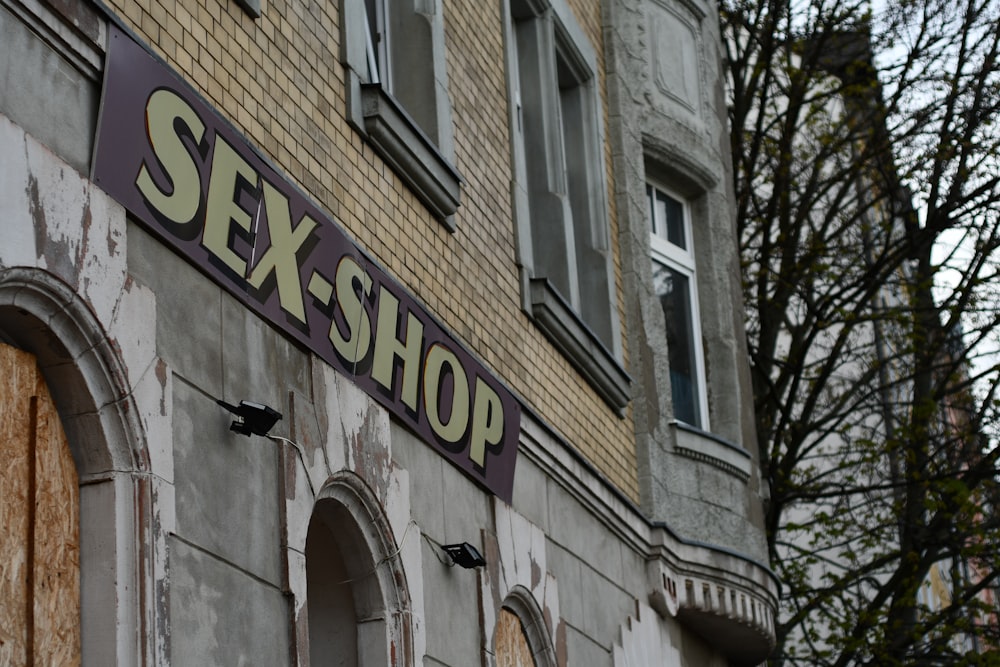 a sign that reads sex shop on the side of a building