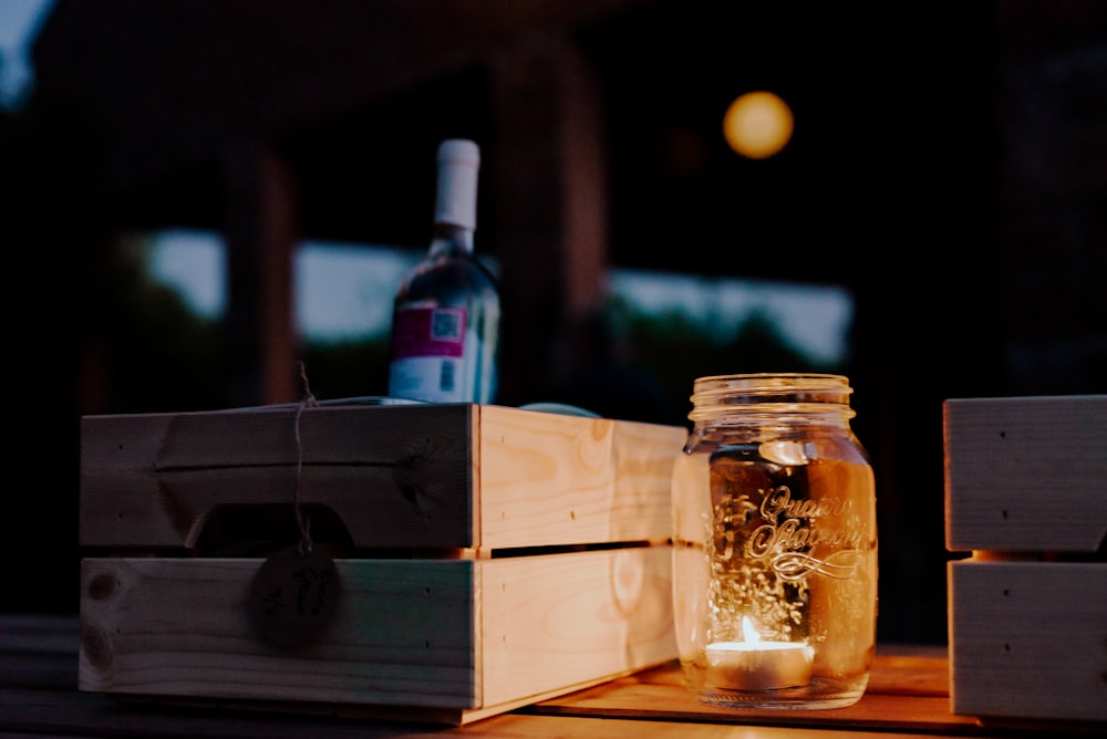 a bottle of wine sitting on top of a wooden box