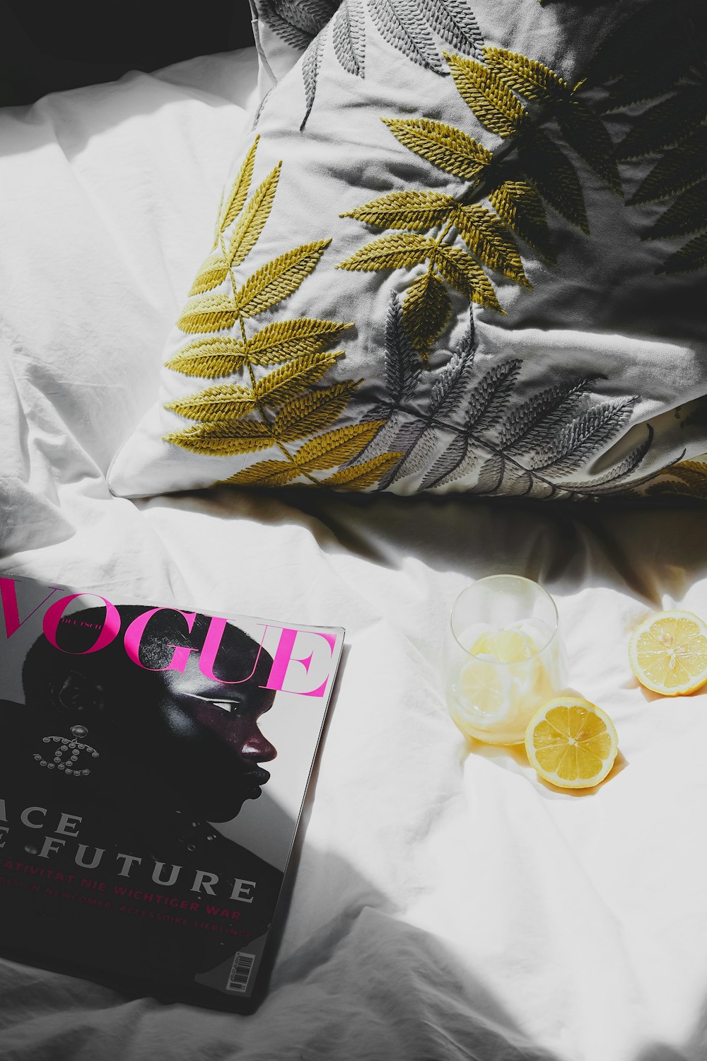 a magazine sitting on top of a bed next to lemon slices