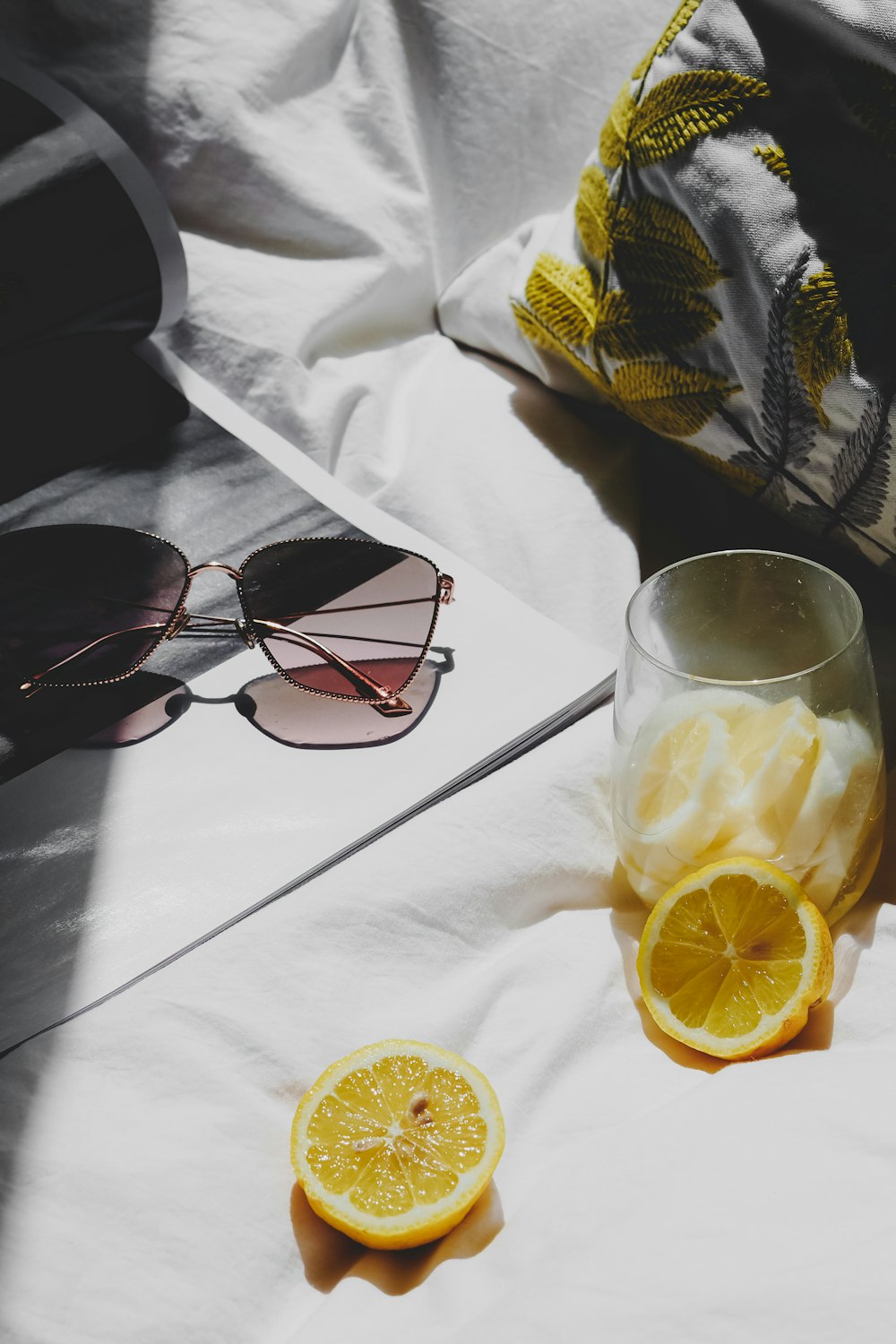 a half of a lemon next to a pair of sunglasses