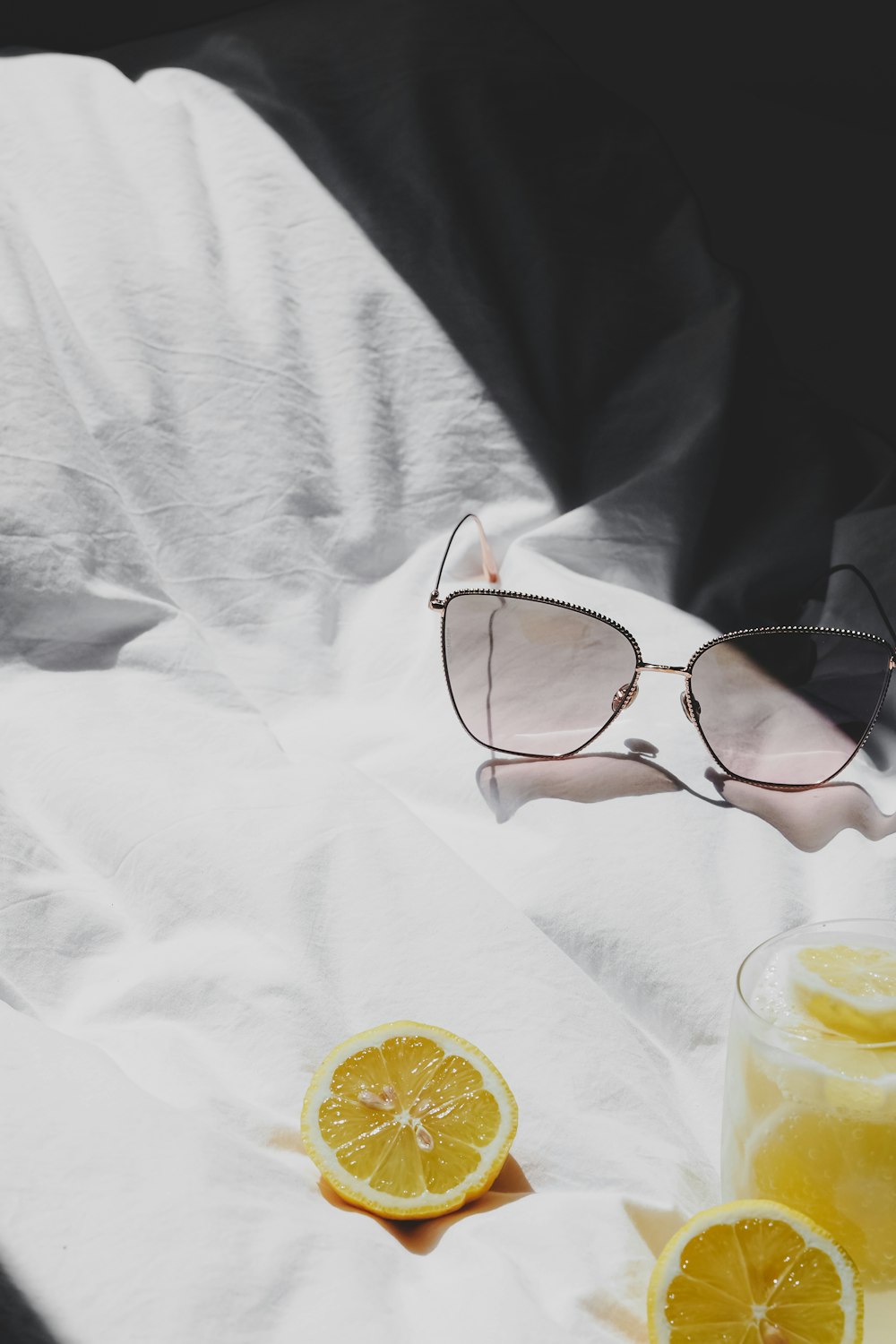 a pair of glasses sitting on top of a white sheet