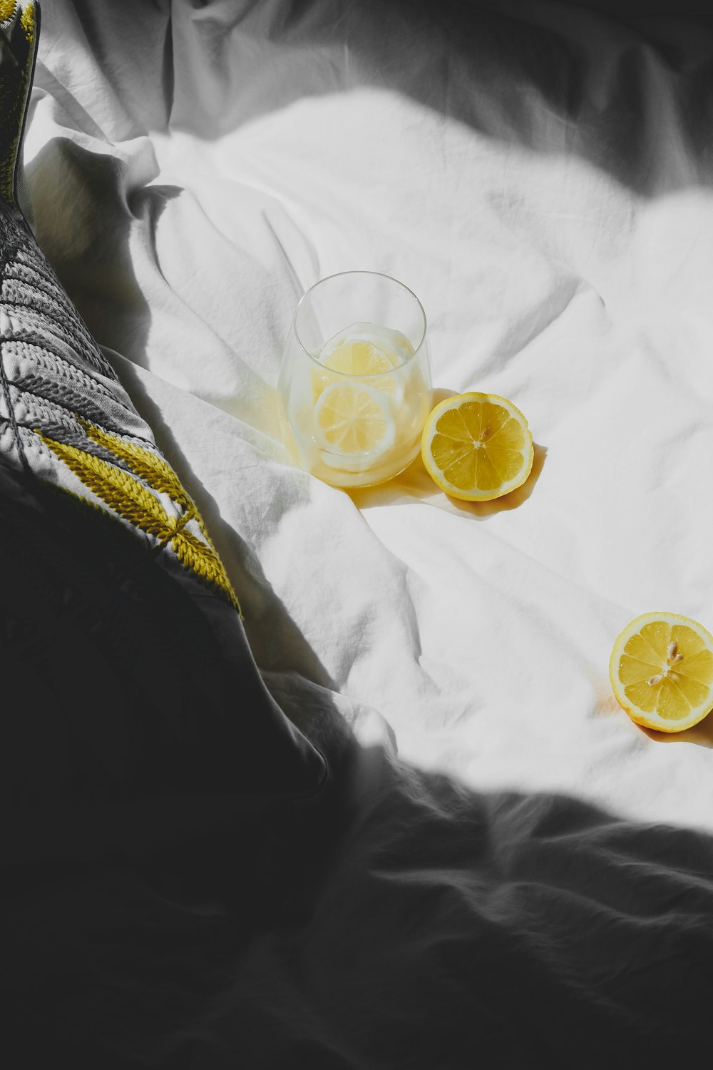 a pair of lemons sitting on top of a bed