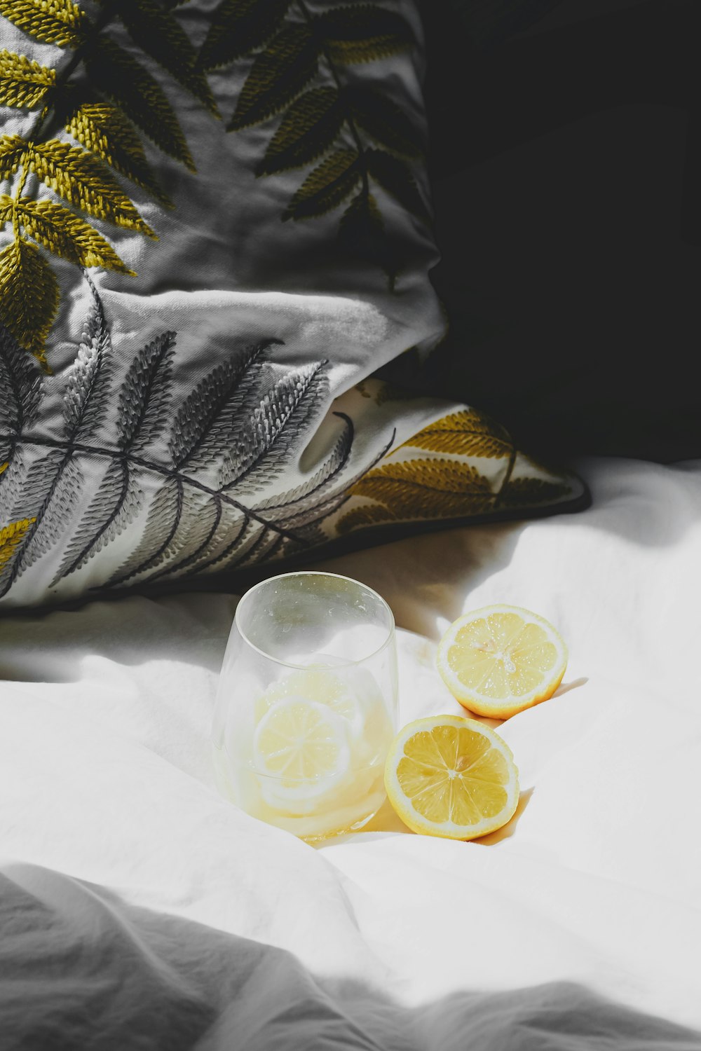 a couple of lemons sitting on top of a bed