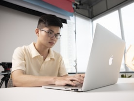 a man sitting in front of a laptop computer