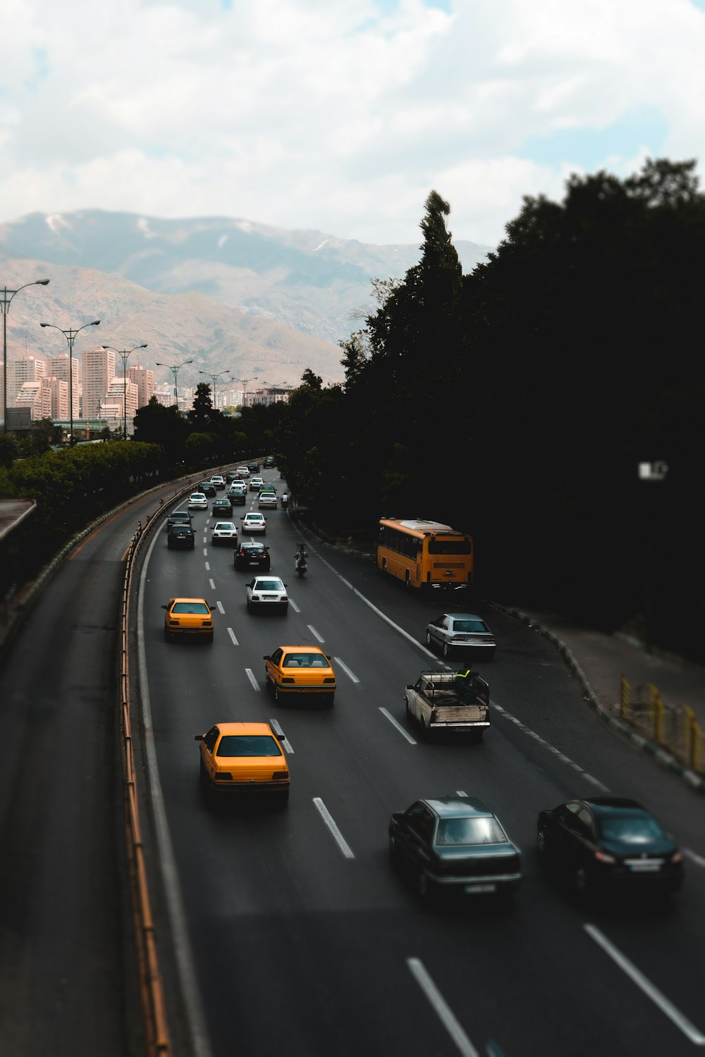 a highway filled with lots of traffic next to tall buildings