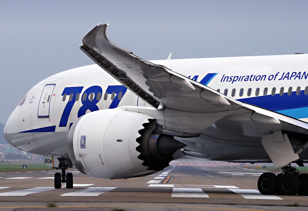 a large jetliner sitting on top of an airport runway