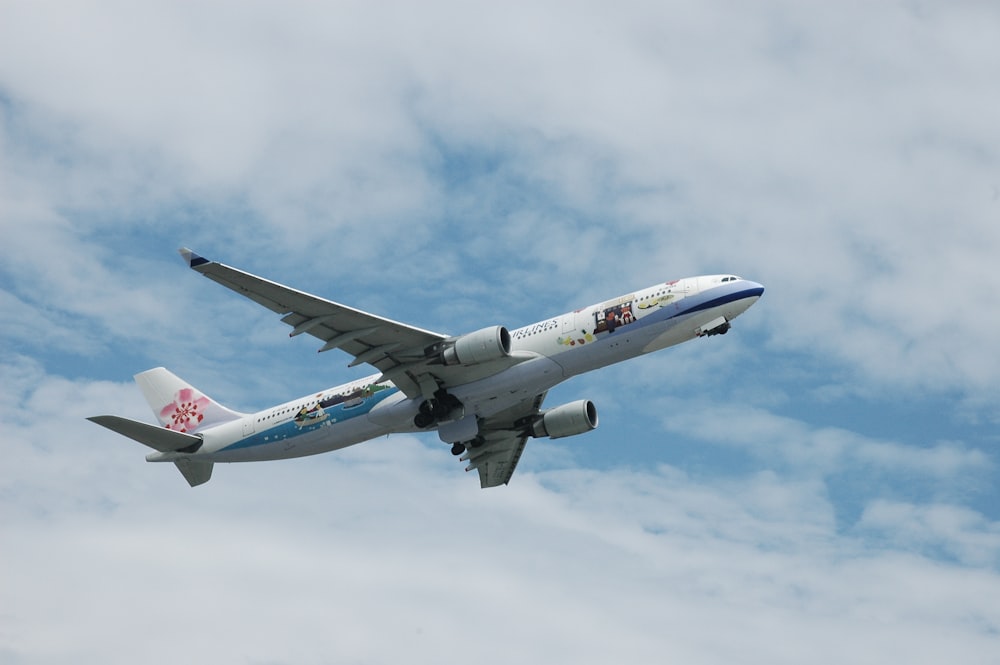 a large passenger jet flying through a cloudy blue sky