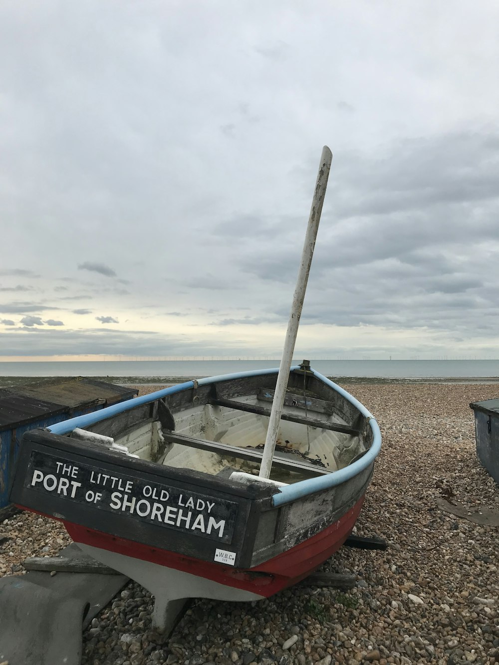 a small boat sitting on top of a rocky beach