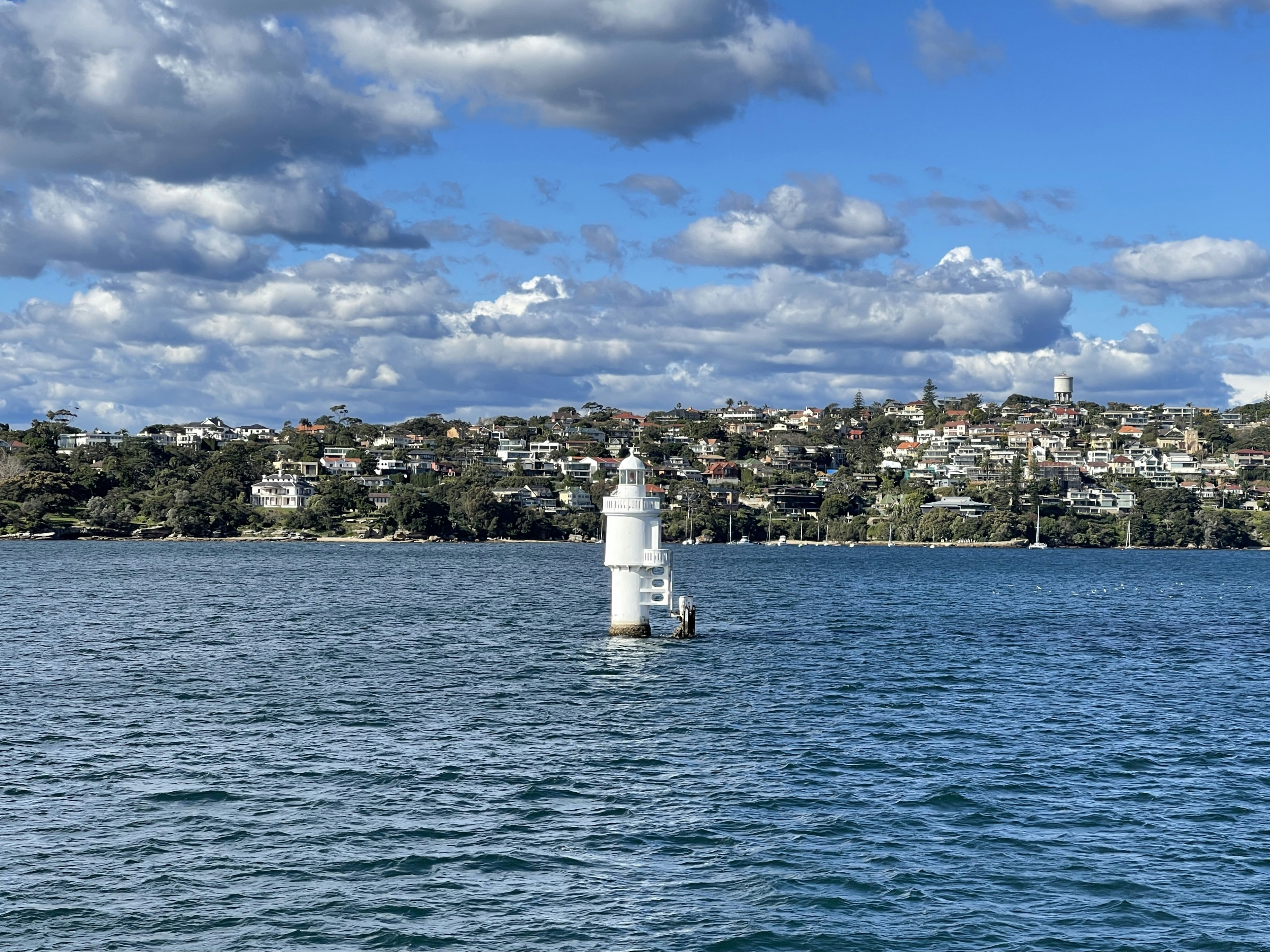 a lighthouse in the middle of a body of water