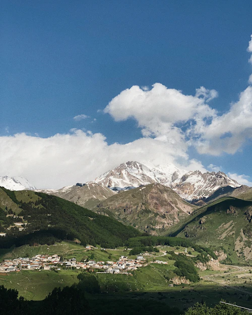 Mountain range above a small town in the Kazbegi area of the country of Georgia
