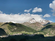 Snow-capped Himalayan peaks towering above a peaceful mountain village.