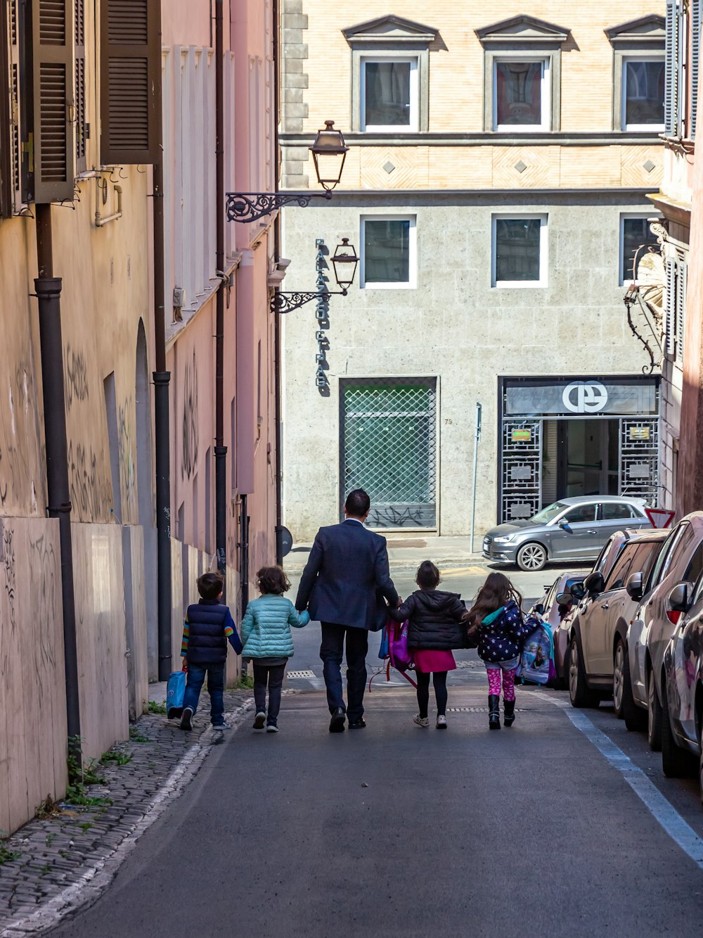 a man and two children walking down a street