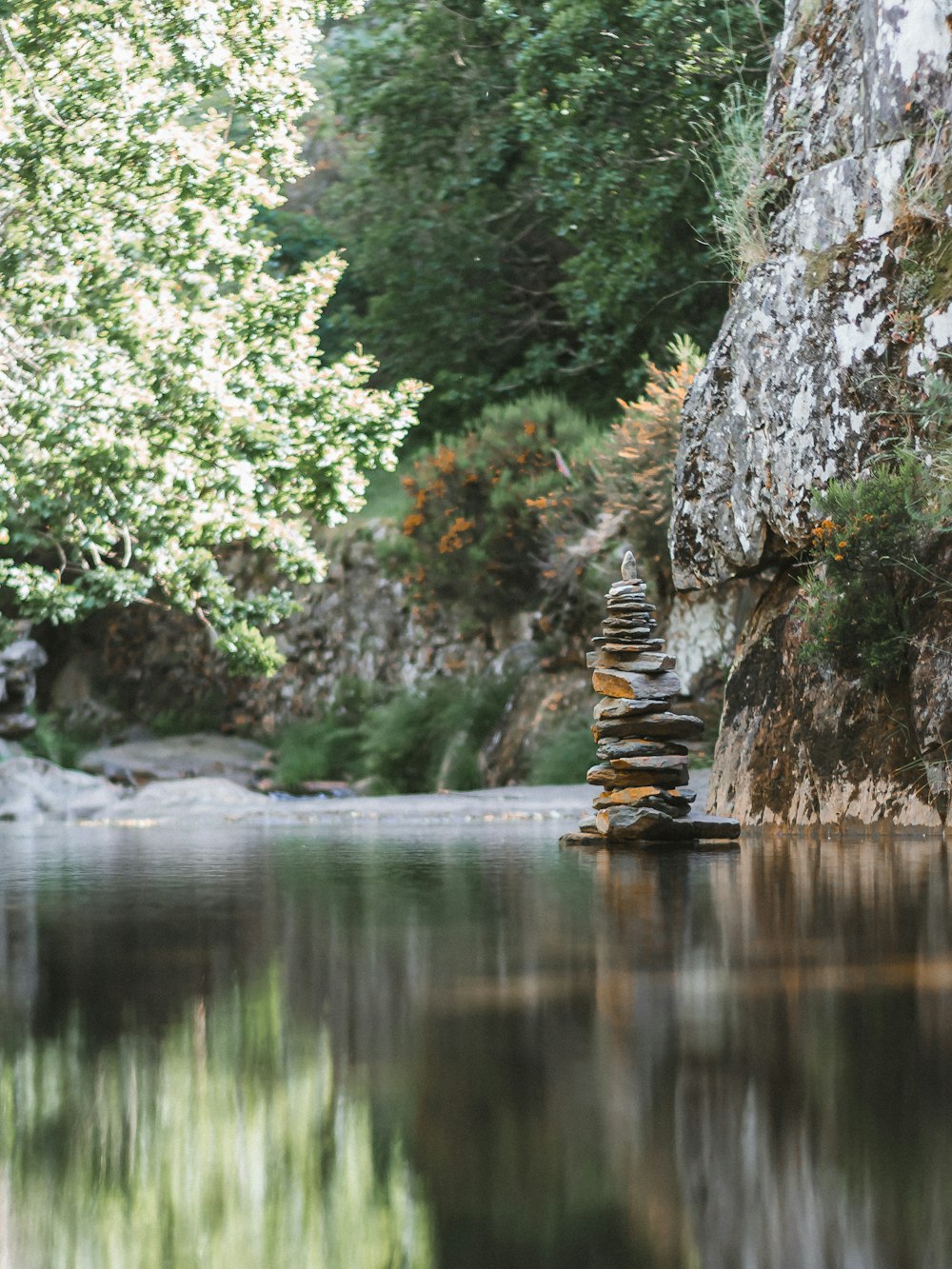 a river that has some rocks stacked on top of it