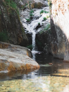 a stream of water running between two large rocks