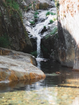 a stream of water running between two large rocks