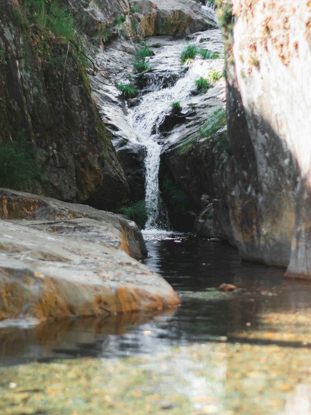 a stream of water running between two large rocks