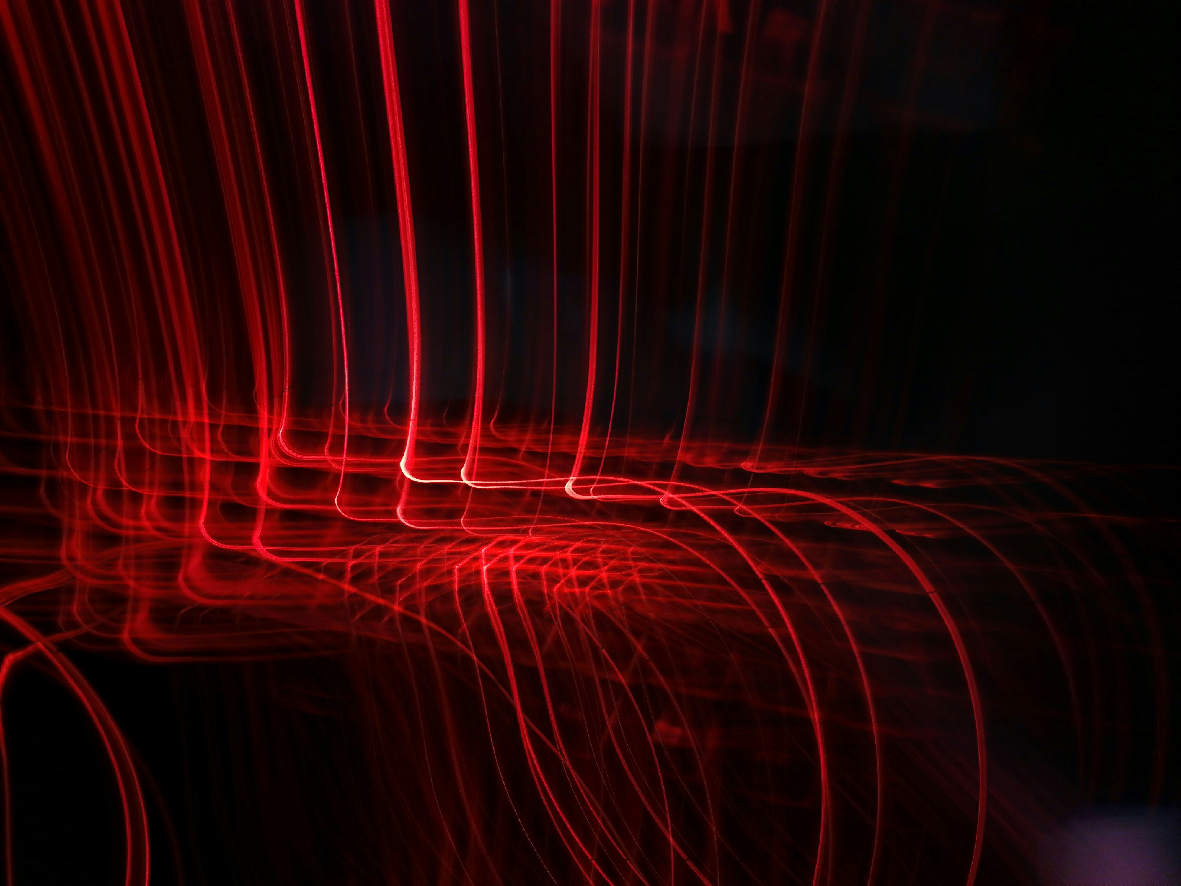 a dark background with red lines in the middle