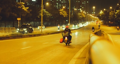 A motorcycle being transported through a city street during daylight.