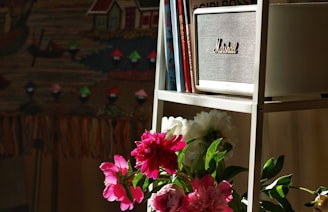 a shelf with a vase of flowers on top of it