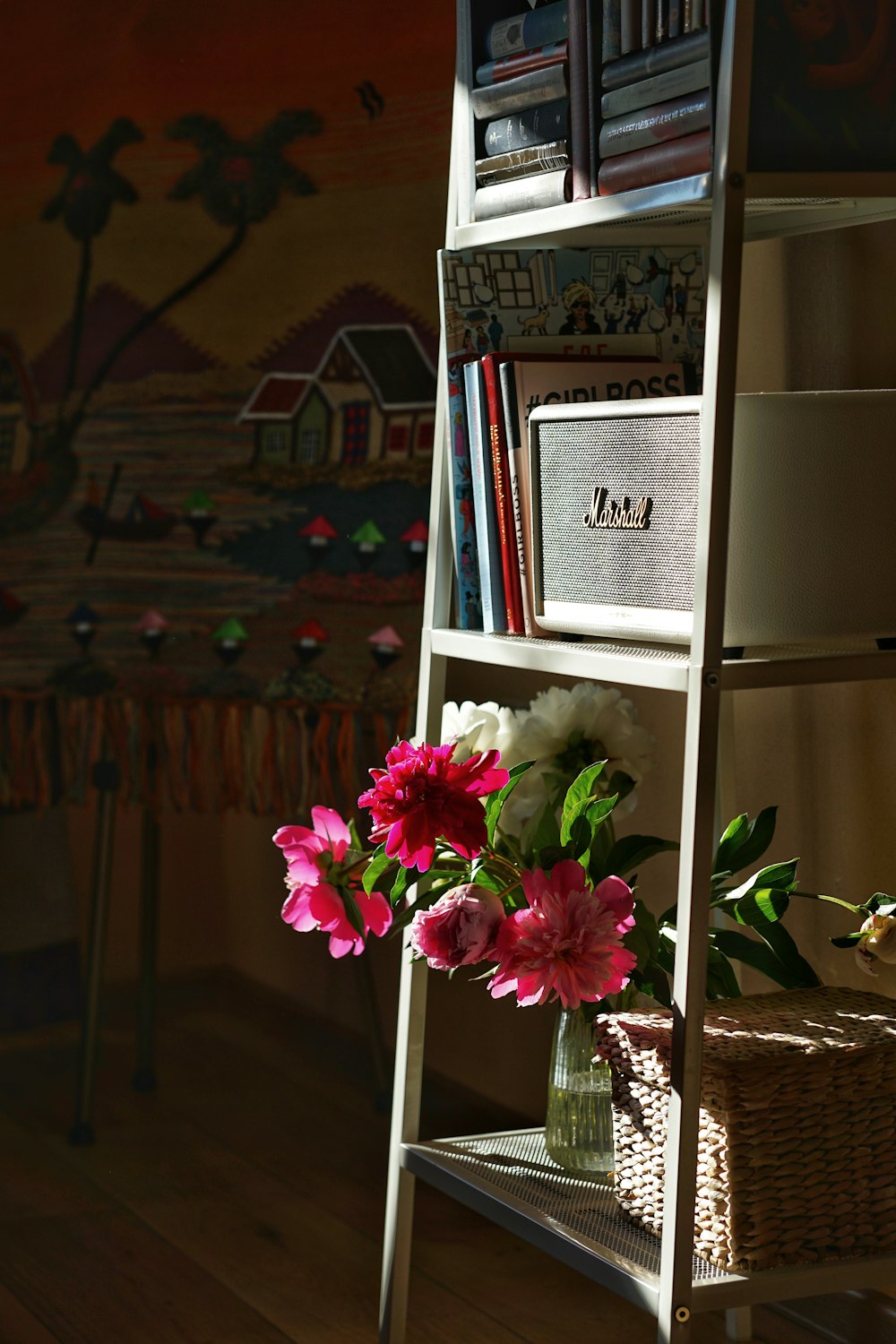 a shelf with a vase of flowers on top of it