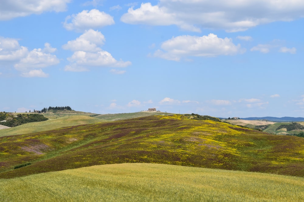 a grassy hill with a house on top of it