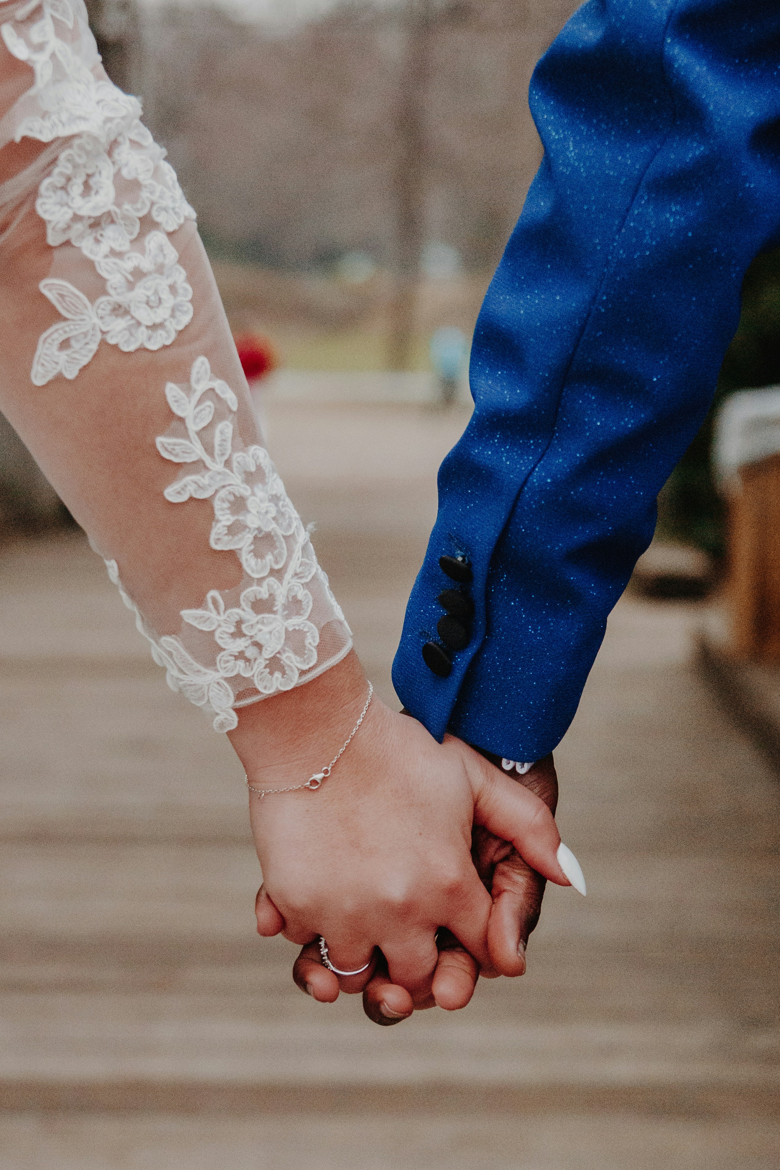 a close up of two people holding hands