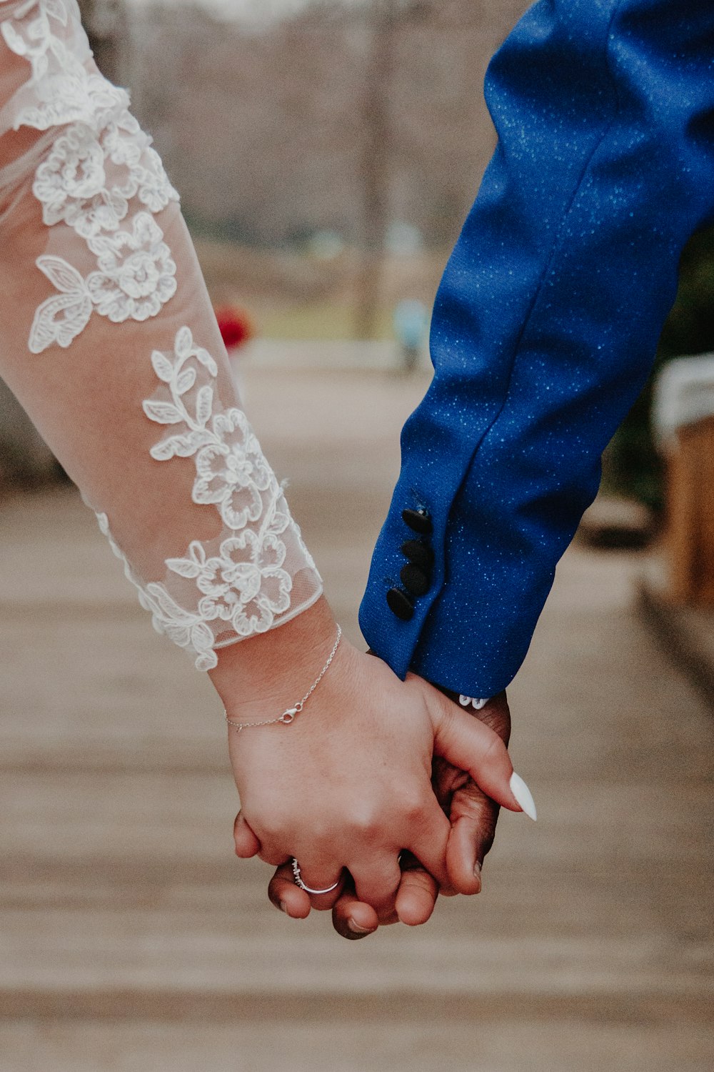 a close up of two people holding hands