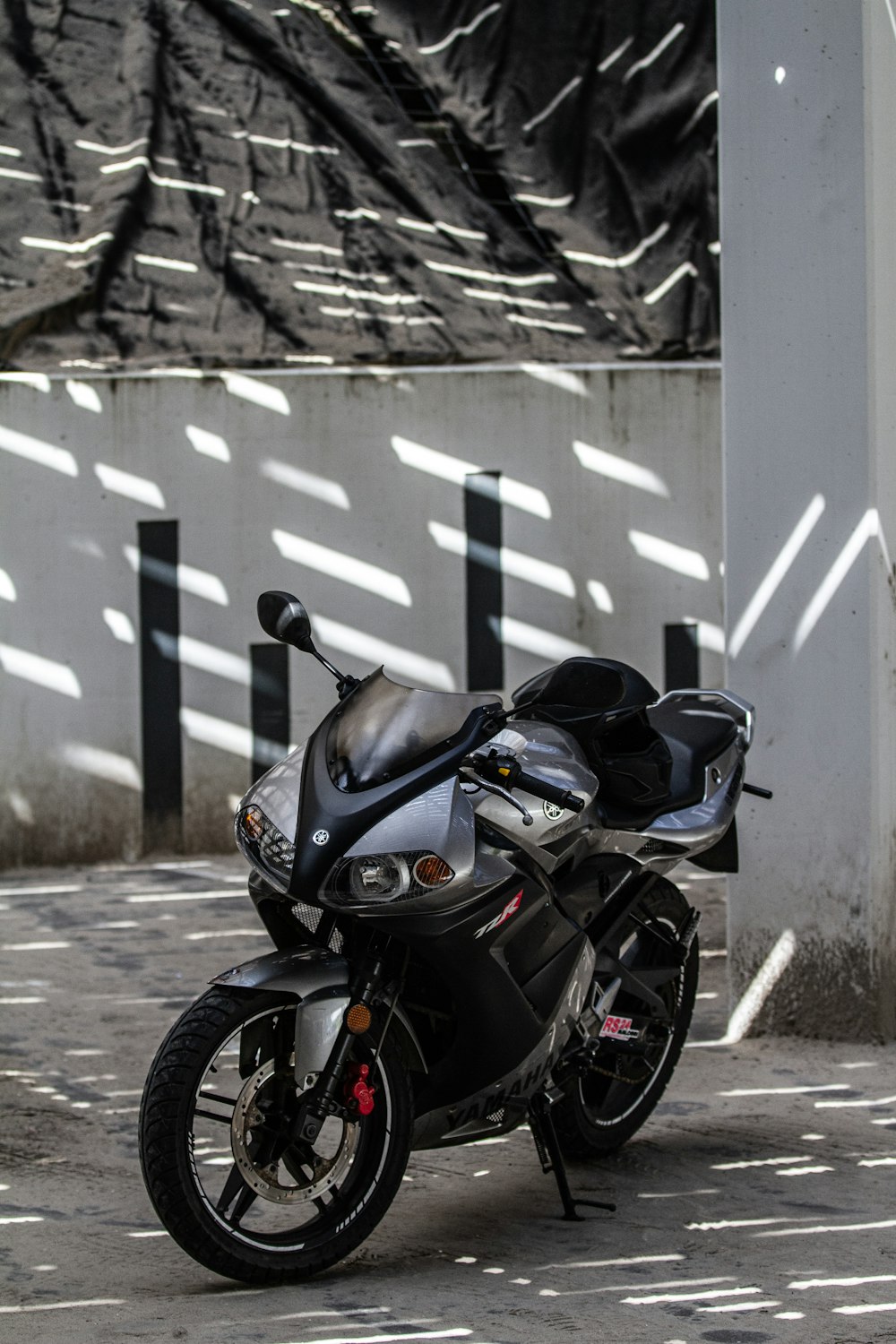 a black motorcycle parked next to a building