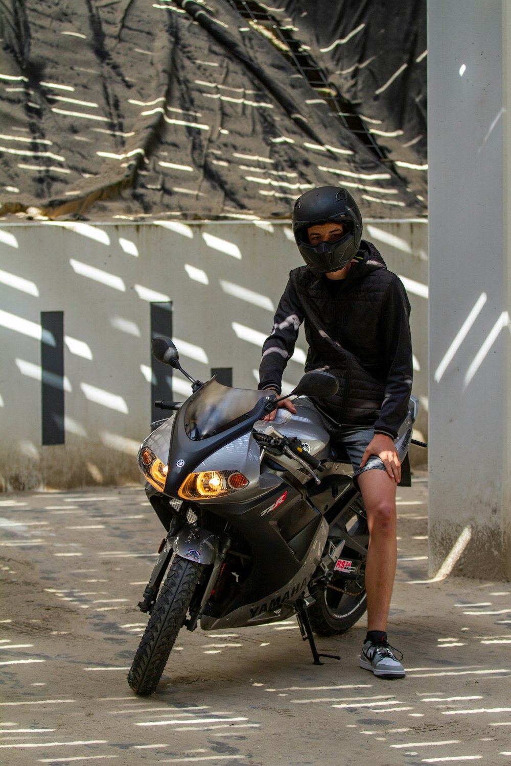 a man wearing a helmet sitting on a motorcycle