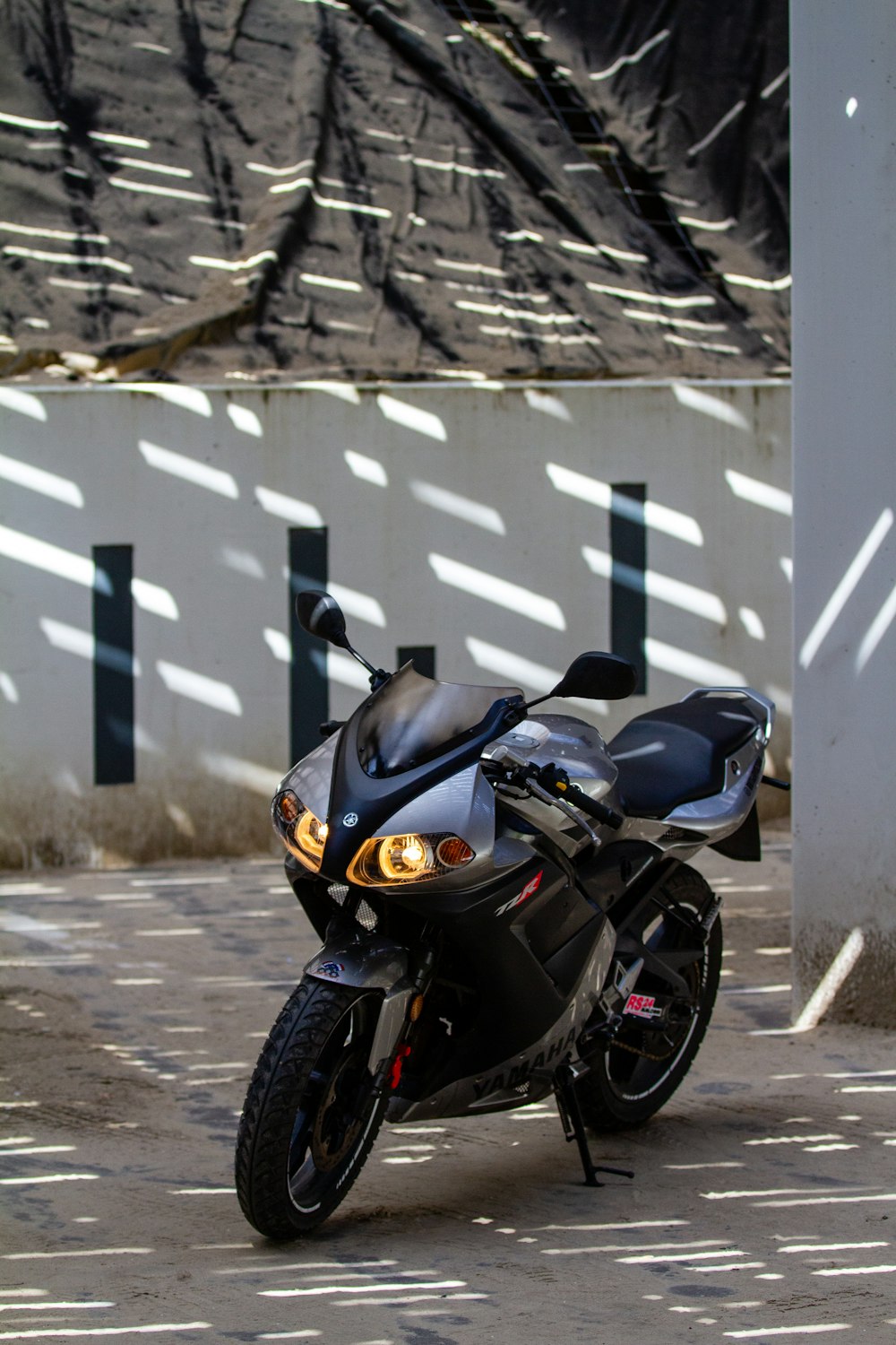 a black motorcycle parked in a parking lot