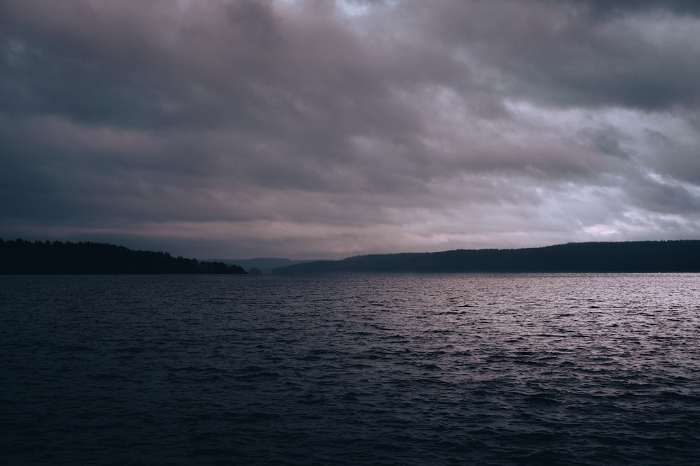 a large body of water under a cloudy sky