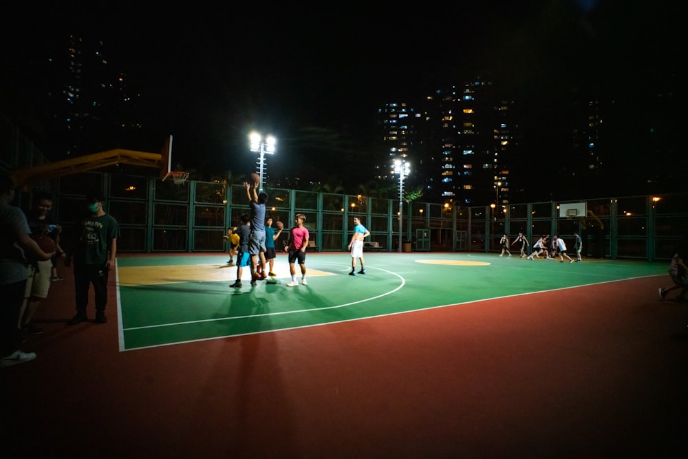 a group of people standing on top of a basketball court