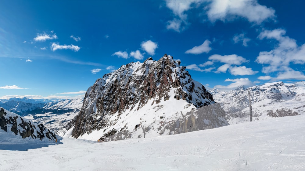 a mountain covered in snow under a blue sky