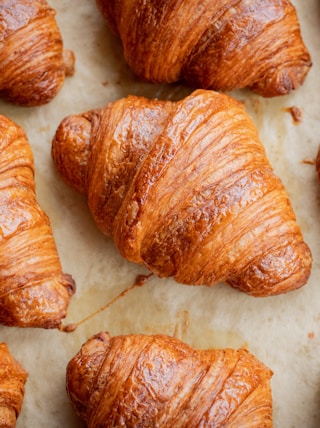 a bunch of croissants that are on a table