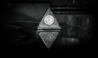 a small clock sitting on top of a table