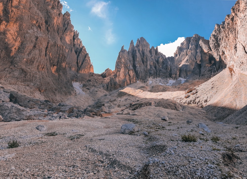 a view of a rocky mountain range from the ground