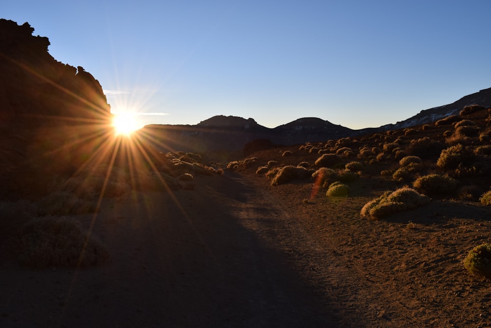 the sun shines brightly over a desert landscape