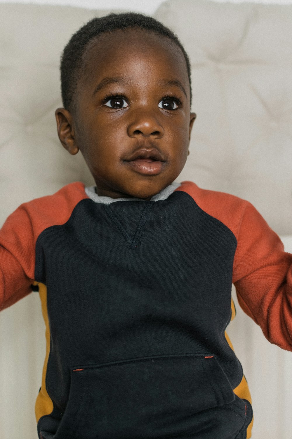 a young boy holding a toothbrush in his hand