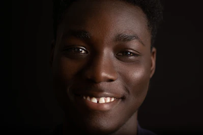 A warm, artistic portrait of a smiling person in a modern digital painting style