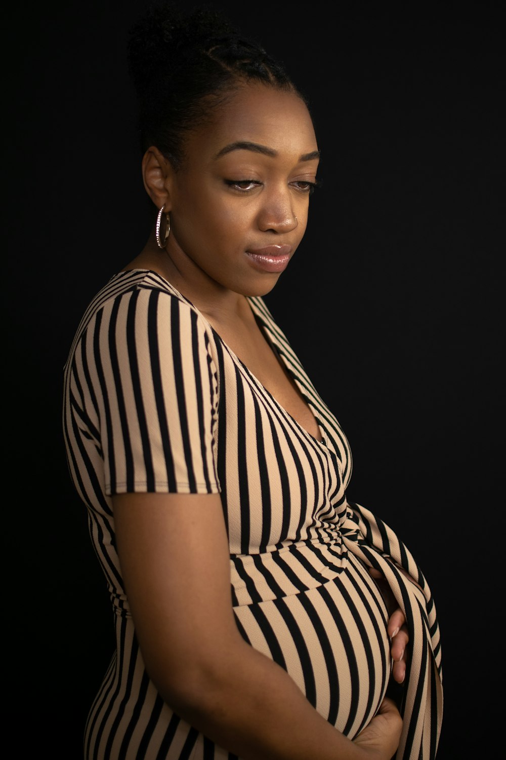 a pregnant woman in a striped dress