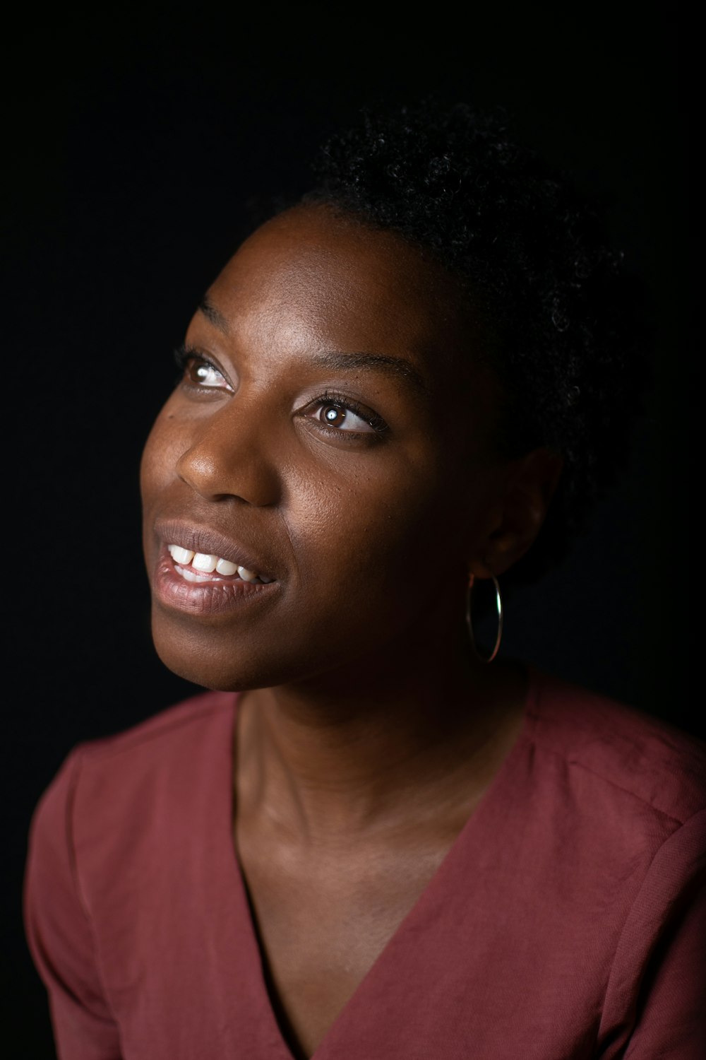 a woman in a red shirt is smiling