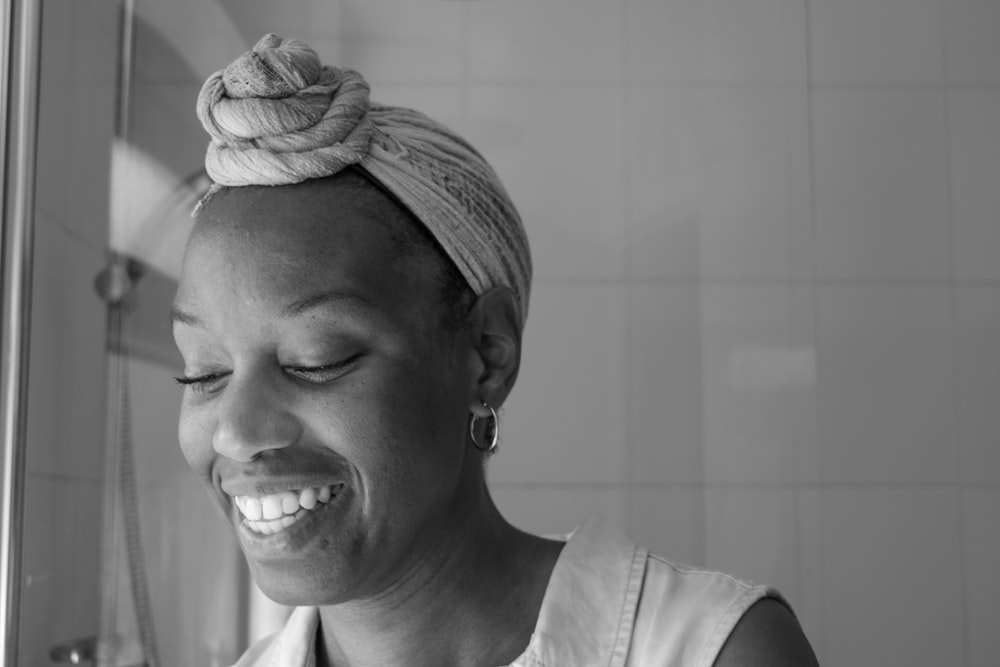 a woman with a towel on her head is smiling