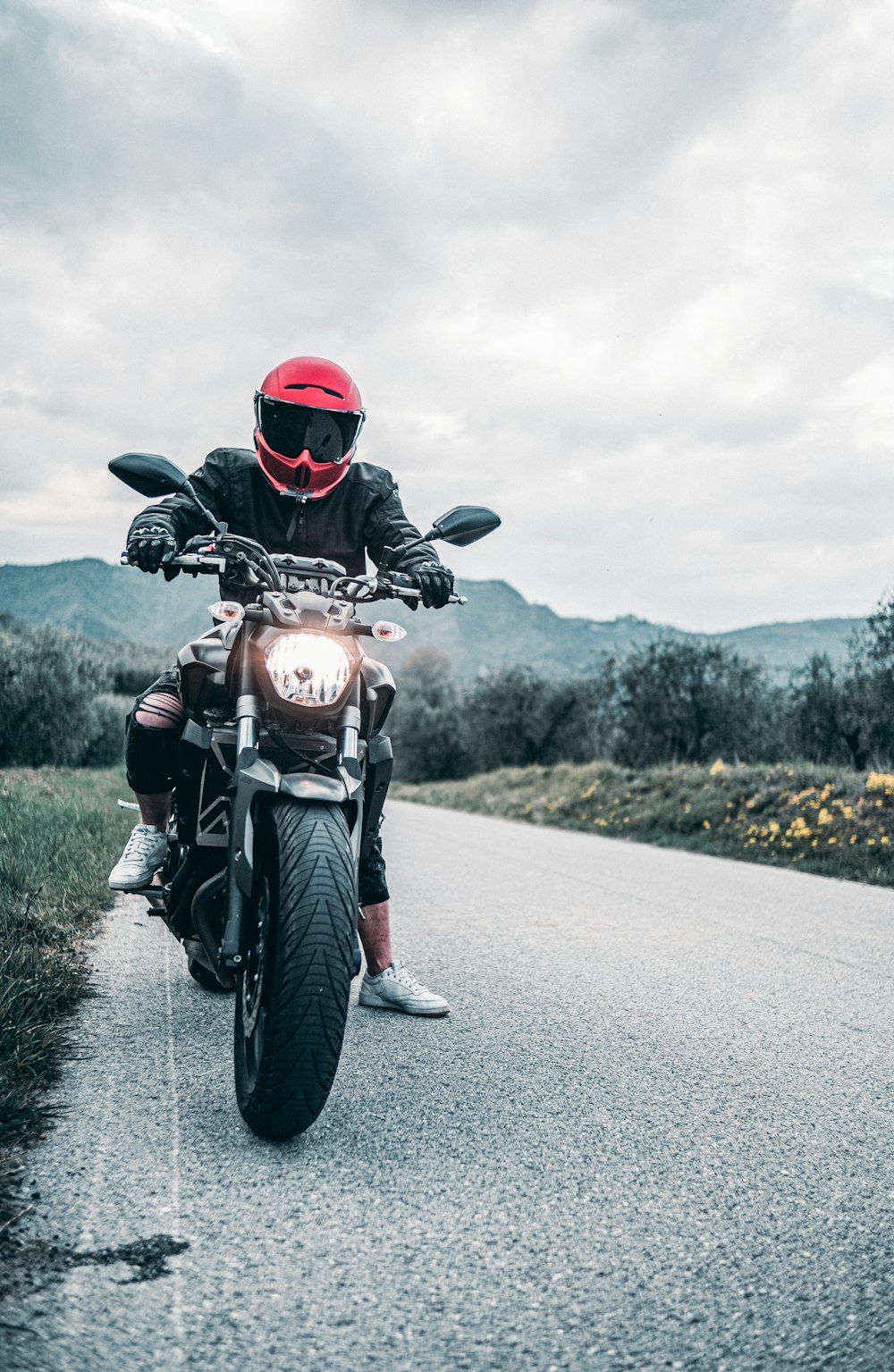 a man riding a motorcycle down a curvy road