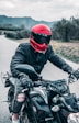 a man riding a motorcycle down a country road