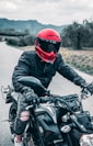 a man riding a motorcycle down a country road