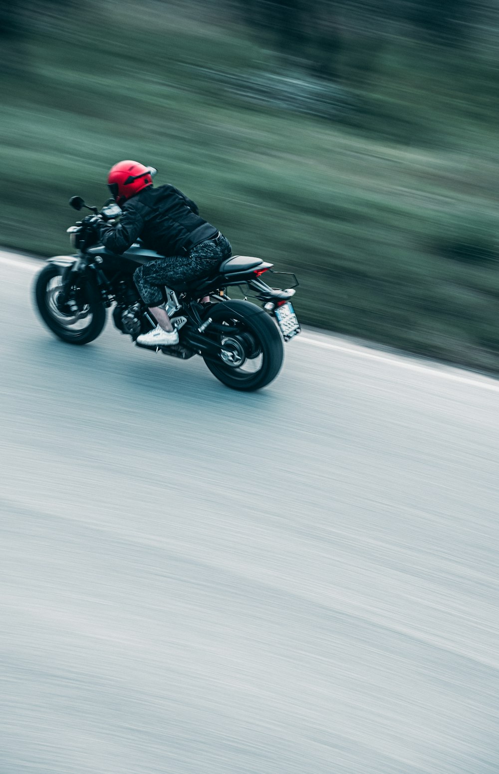 a man riding a motorcycle down a street