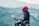 a man riding a motorcycle with a mountain in the background